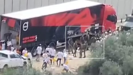 Israeli soldiers look on as settlers loot aid trucks bound for Gaza – video