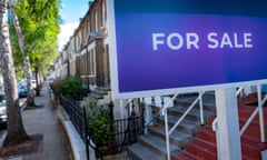 a purple-blue for sale sign on a terraced street
