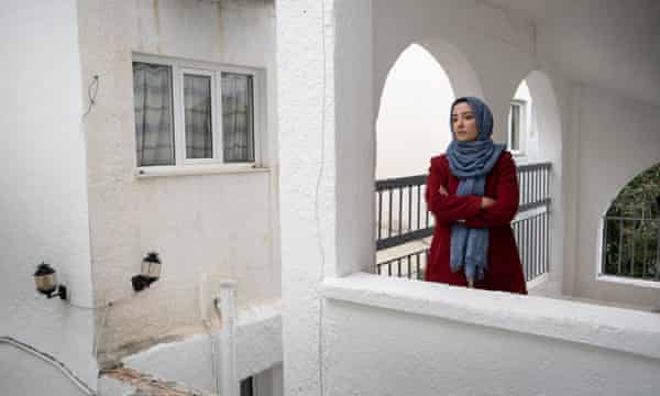 Shagufa Noorzai, MP for Helmand province, looks out from a balcony at the beach resort where she and her family share a small room.