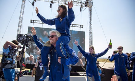 Virgin Galactic founder Richard Branson carries crew member Sirisha Bandla on his shoulders while celebrating their flight to space on 11 July.