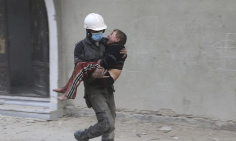 In this photo released on Wednesday Feb. 21, 2018, provided by the Syrian Civil Defense group known as the White Helmets, shows a member of the Syrian Civil Defense group carries a boy who was wounded during airstrikes and shelling by Syrian government forces, in Ghouta, a suburb of Damascus, Syria. New airstrikes and shelling on the besieged, rebel-held suburbs of the Syrian capital killed at least 10 people on Wednesday, a rescue organization and a monitoring group said. (Syrian Civil Defense White Helmets via AP)