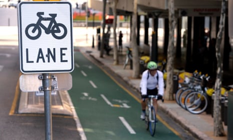 A cyclist rides his bike on a bike lane in Brisbane