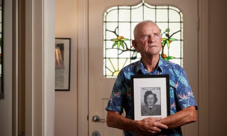 Patrick McGowan holding a framed picture of his mother.