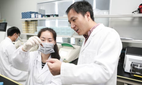 He Jiankui (right) guides a laboratory staff member at a genomics lab in Shenzhen, China, in 2016