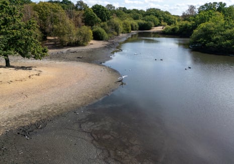 An aerial view shows the dried and cracked bed of the depleted Hollow Pond and Leyton flats near Wanstead, east London, on 10 August 2026.
