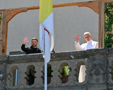 Ukraine’s President Volodymyr Zelenskyy (L) and Pope Leo XIV wave from a balcony as they meet at the papal residence of Castel Gandolfo, southeast of Rome.