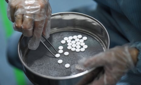 A worker weighs drugs at a pharmaceutical company in Haikou, in China’s Hainan province.