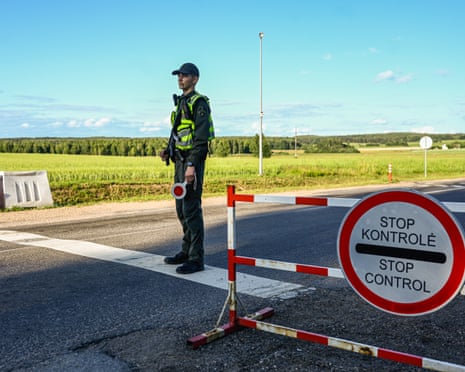 A Lithuanian border guard officer stands on a check point next to the Lithuanian Belarusian border on in Dieveniskes, Lithuania.
