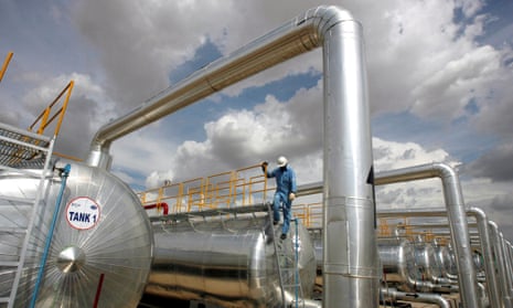 An employee at Cairn India, a unit of the UK-based company formerly known as Cairn Energy, works at a storage facility for crude oil at Mangala oil field at Barmer in the desert Indian state of Rajasthan.
