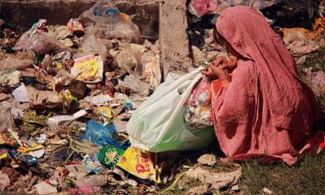 Eight-year old Zarmeena collecting rubbish from pile in Islamabad.