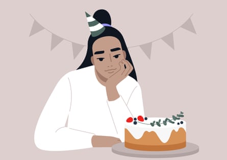 A young woman sadly contemplates a cake decorated with strawberries and gum leaves