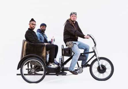 Rickshaw driver Daniel with sales employees Steven and Demetrius in a Paddycab in Venice Beach, LA, US.
