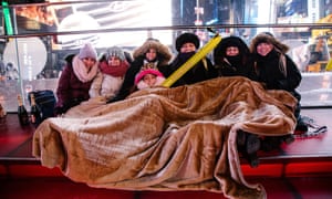 New Year revellers bundle up against the cold in Times Square, New York.