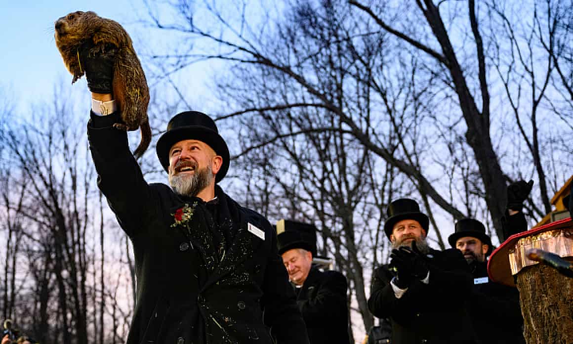 Groundhog handler AJ Dereume holds Punxsutawney Phil after he saw his shadow predicting 6 more weeks of winter.