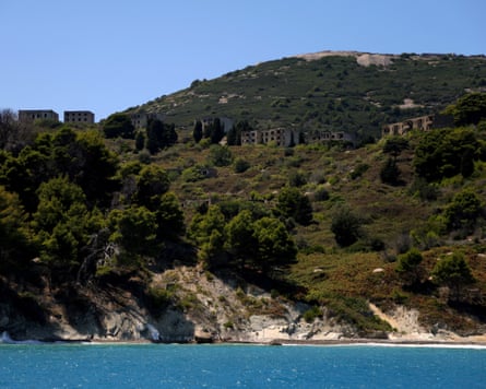 Abandoned barracks on a hilltop overlooking the blue waters of Sazan Island.