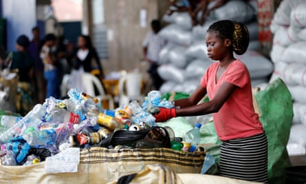 An worker sorts waste at a recycling centre in Lagos