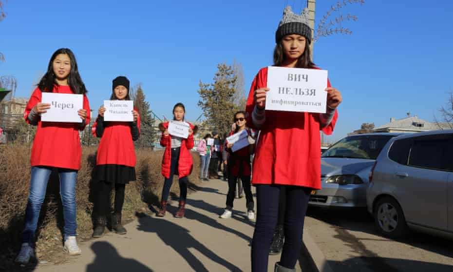 Volunteers in Kyrgyzstan raise awareness about HIV/Aids by holding signs explaining how HIV can and cannot be transmitted.