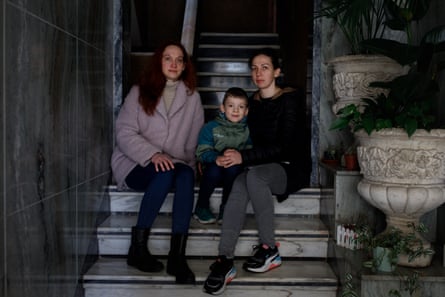 From left to right: Kateryna Skrebtsov, Seva Skrebtsov and Alina Levchenko in the stairwell of their temporary home in Lisbon, Portugal, March 2022. They have remained in Lisbon, but have moved into different apartments.