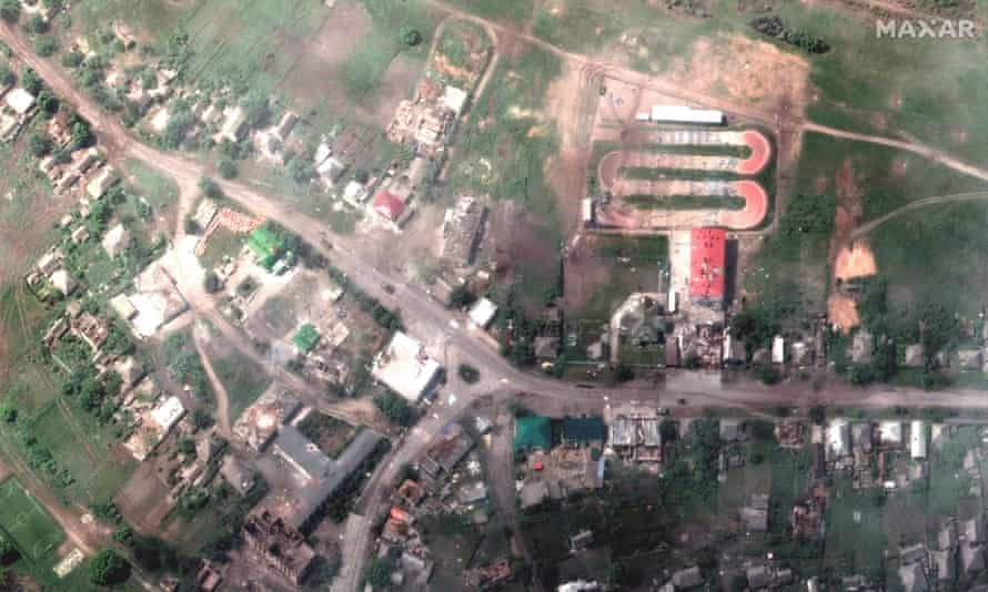A satellite image shows damaged buildings and a tank on a road, in Lyman, Ukraine on 25 May.