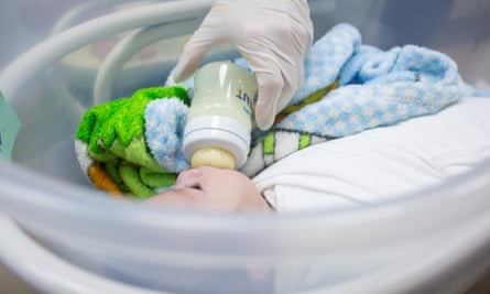 A nurse feeds a baby in Kyiv in March 2022.