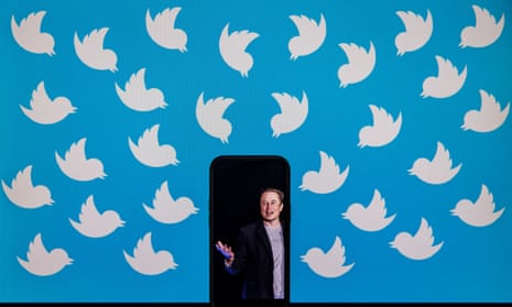 In this file photo illustration taken on August 05, 2022, shows a cellphone displaying a photo of Elon Musk placed on a computer monitor filled with Twitter logos in Washington, DC.