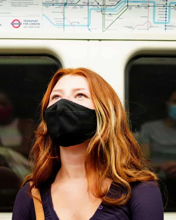 Woman wearing a facemask on a train