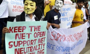 Activists wear Guy Fawkes masks as they hold placards during a demonstration supporting net neutrality in Bangalore