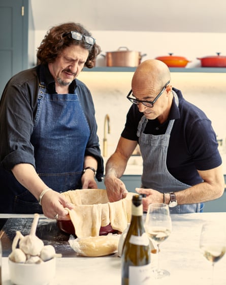 Jay Rayner and Stanley Tucci line a baking dish with pasta-pastry