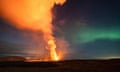 Lava and smoke plumes spewing from a volcano near Grindavík, Iceland, are illuminated by the northern lights