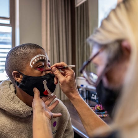 Ayabonga Tshofui, a College of Magic student, has his face painted before a performance at the Artscape theatre centre.
