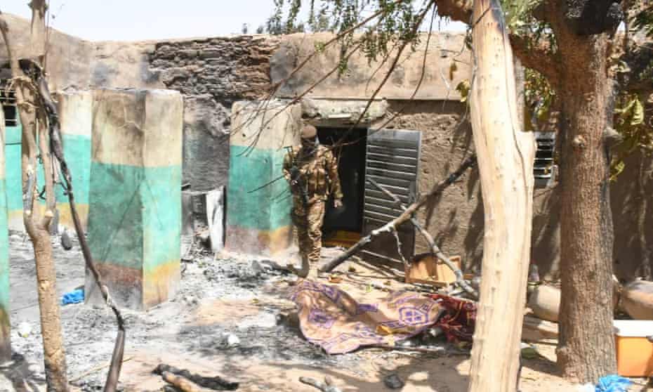 A soldier walks amid damage after an attack by gunmen in Ogossagou, Mali. Increasing intercommunal violence and the presence of armed groups has resulted in repeated attacks in central Mali. 