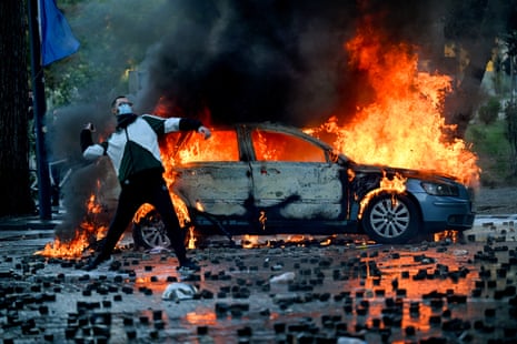 A protester throws a cobblestone during an anti-government demonstration in central Tirana Saturday