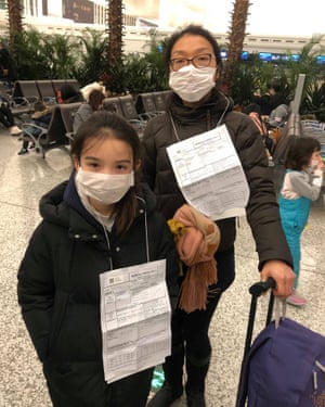 Jeff Siddle’s wife, Sindy, and daughter, Jasmine; at the airport the family were asked to wear medical reports around their necks