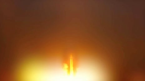 A still image showing a bright light from a missile being launched.