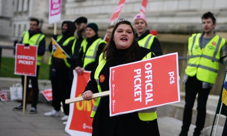 Members Public and Commercial Services (PCS) union of on the picket line outside the office of HM Treasury, in Westminster.
