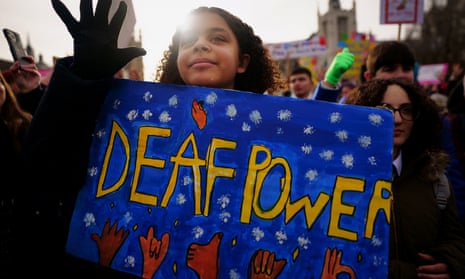 A school girl takes part in a rally in support of British Sign Language becoming a recognised language  outside the Houses of Parliament in January 2022