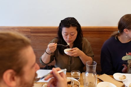 A reviewer tasting a sample of sauerkraut.