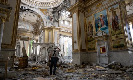 Ukrainian workers inspect damage to Odessa's Transfiguration Cathedral after Russian missile attack