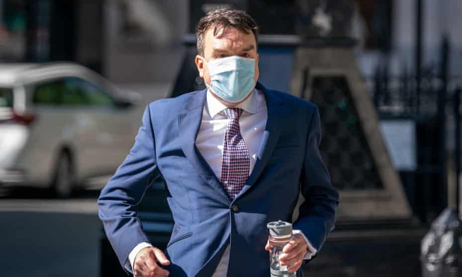 Andrew Griffiths in face mask looking flustered