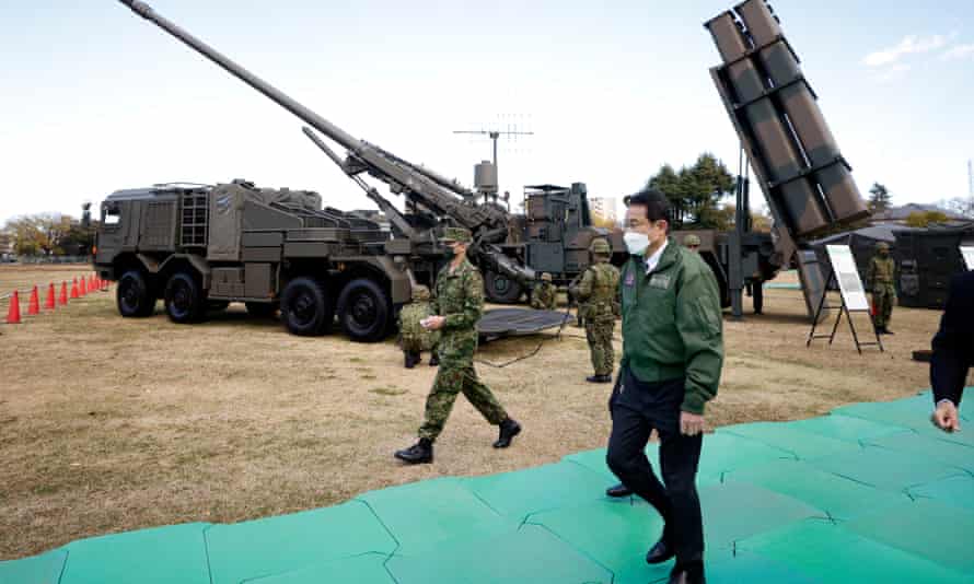 Fumio Kishida inspects military equipment at Camp Asaka