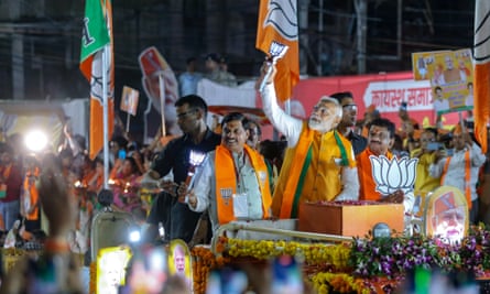 Narendra Modi, centre, greets supporters during a roadshow in Bhopal before the second phase of voting