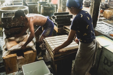 Workers at a tofu factory in the village of Tropodo, East Java, Indonesia, where scrap plastic is burned as a cheap source of fuel. Tropodo, East Java, Indonesia. February 2025.
