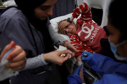 A Palestinian child from Gaza suffering from malnutrition, receives medication aboard an Etihad Airways flight heading to Abu Dhabi to receive treatment, at Ilan and Asaf Ramon International Airport, in Be’er Ora, Israel on 14 May.
