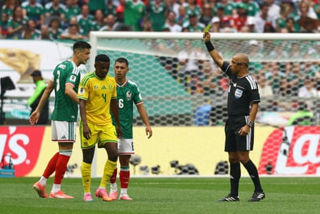 South Africa’s Teboho Mokoena is shown a yellow card by referee Wilton Sampaio.