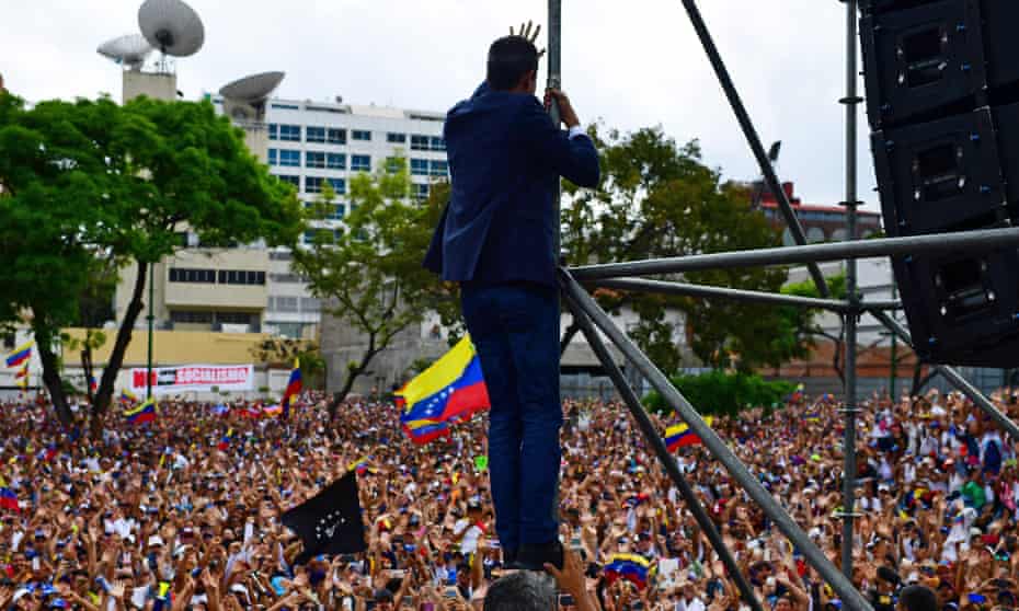 Venezuela’s opposition leader, Juan Guaidó, waves to the crowd during a rally in Caracas in March.