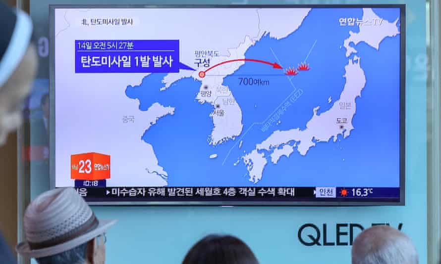 People in Seoul watch a news report on North Korea conducting a missile test launch.