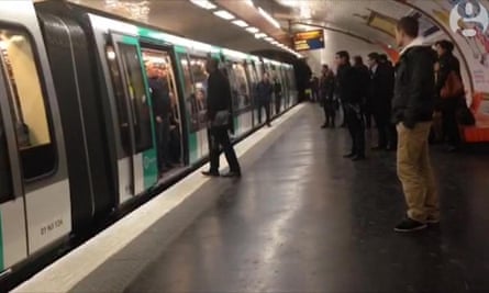 Still from the Guardian video that shows Chelsea fans preventing a black man from boarding a metro train in Paris
