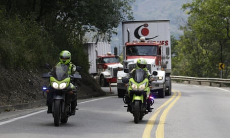 Two semi-trailer trucks containing humanitarian aid from the US for Venezuela are escorted by Colombian police in Los Patios, near Cúcuta, Colombia, on Thursday.