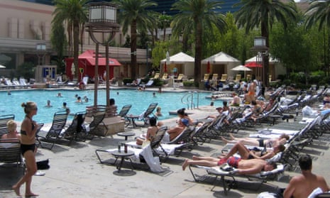 People sunbathing around a hotel pool