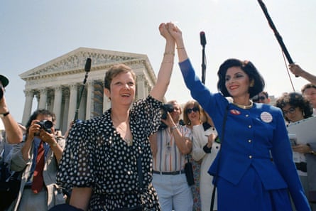 Norma McCorvey, Jane Roe in the 1973 court case, left, and her attorney Gloria Allred hold hands as they leave the Supreme Court building in Washington.